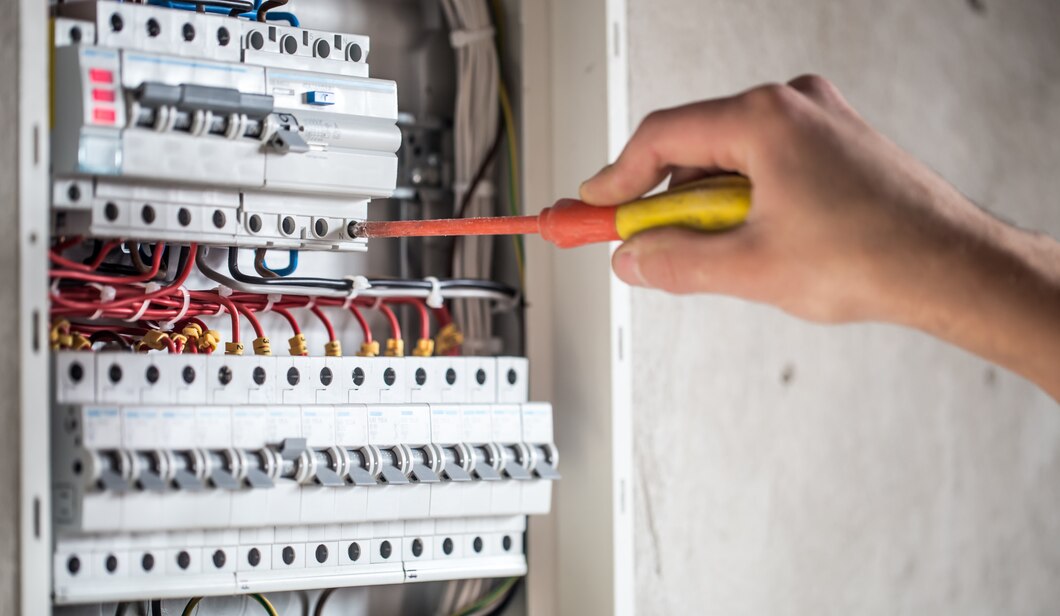 man-electrical-technician-working-switchboard-with-fuses-installation-connection-electrical-equipment_169016-3859 (1)